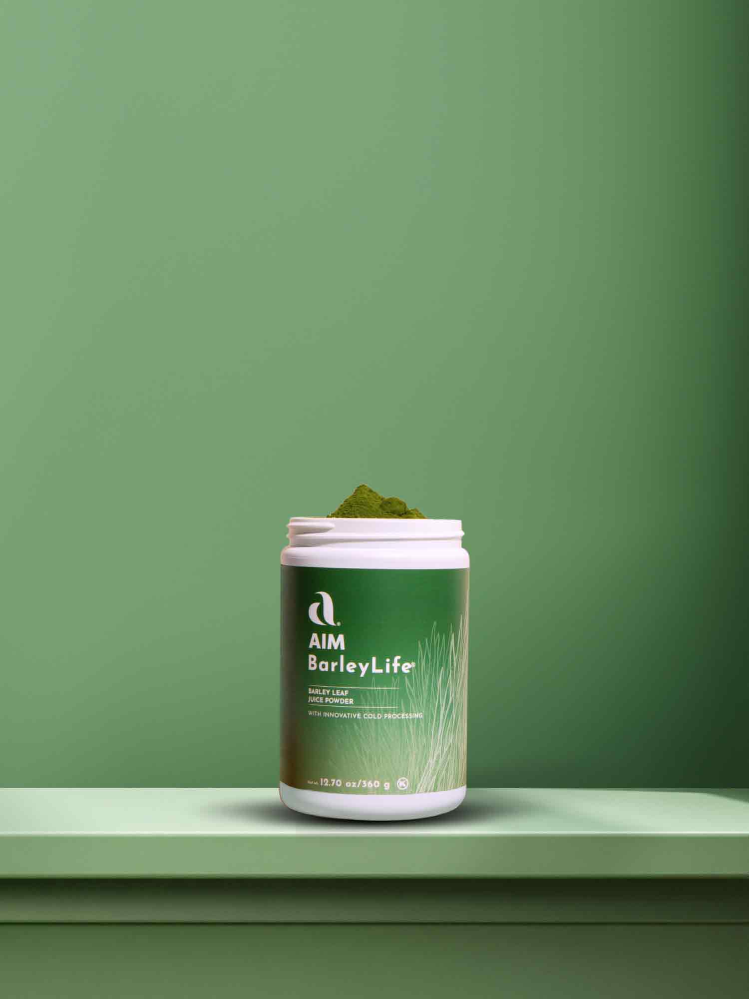 A picture of an open container of BarleyLife overflowing with green barley leaf juice powder in front of a light green background illuminated by diffuse rays of light.  Overlaid text says 'BarleyLife.  Nourish your body with the goodness<br />of our whole food nutrition.' Followed by a Shop Now button.