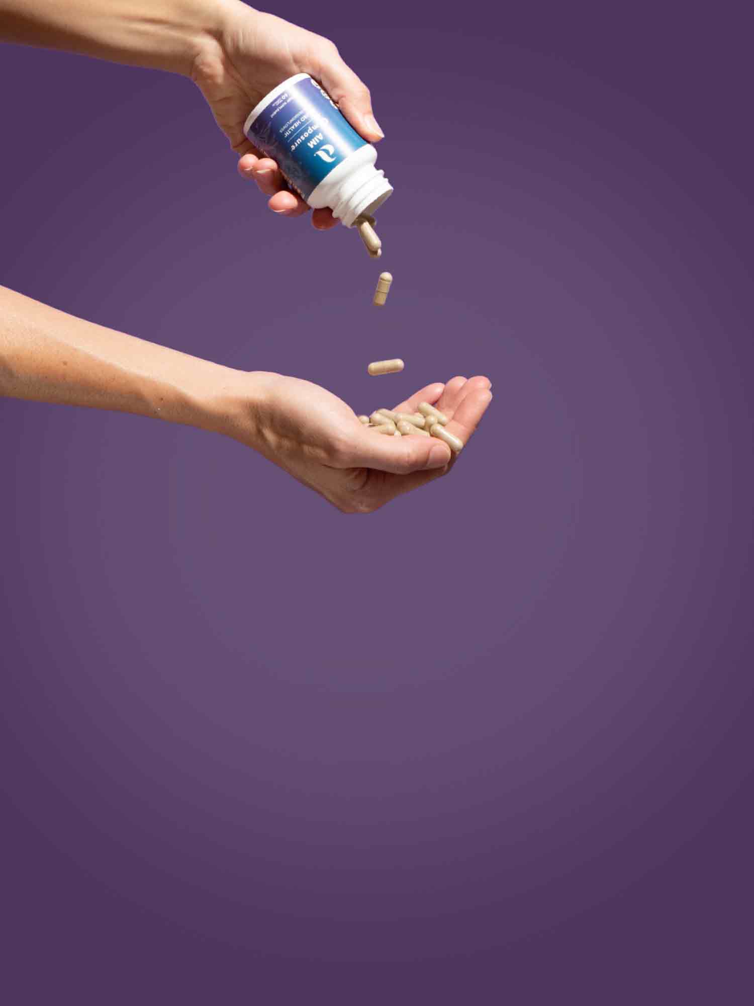 A picture of a container of Composure being emptied with Composure capsules falling into an outstretched hand.  The text says 'Achieve your health goals with our targeted nutritional solutions'.  At the bottom is a button labeled 'Shop Now'